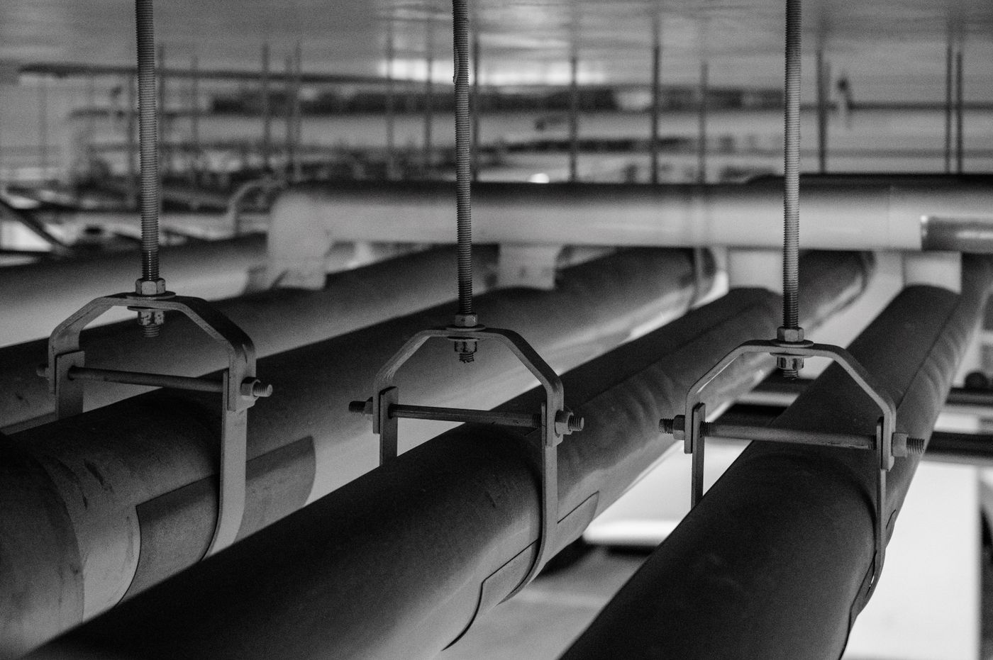 Large suspended drain and distribution mains in a building service ceiling
